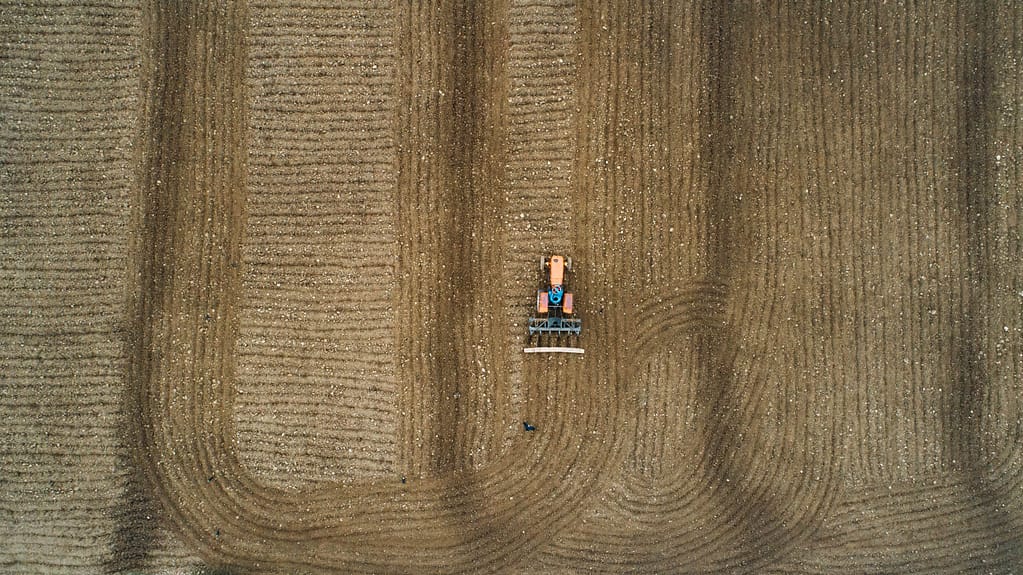 Aerial view of a farmer using a tractor to prepare his field in Pakistan. Photo: IWMI