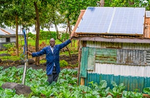 Maurice Owino, a smallholder farmer in Siaya County, Kenya, in his land. His solar-powered irrigation pump has boosted yields and increased resilience to drought. Photo: SunCulture