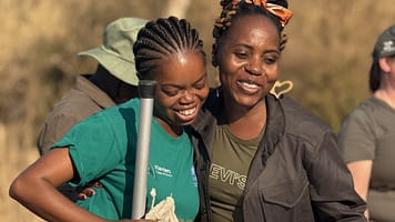 Volunteers in South Africa at a citizen science training. A trainee from Zimbabwe practices a water measurement method.