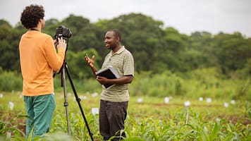 Videographer Milo Mitchell records a video interview in an experimental maize field with a Trans-SEC researcher in Kilosa, Tanzania. Photo: Mitchell Maher / IFPRI