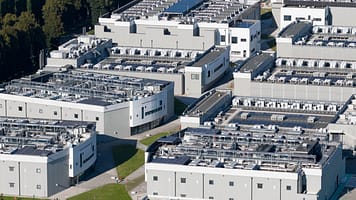 Close up details of data center, computing center, high consumption electricity. Cooling and emergency power. Photo: Make more Aerials/ Shutterstock