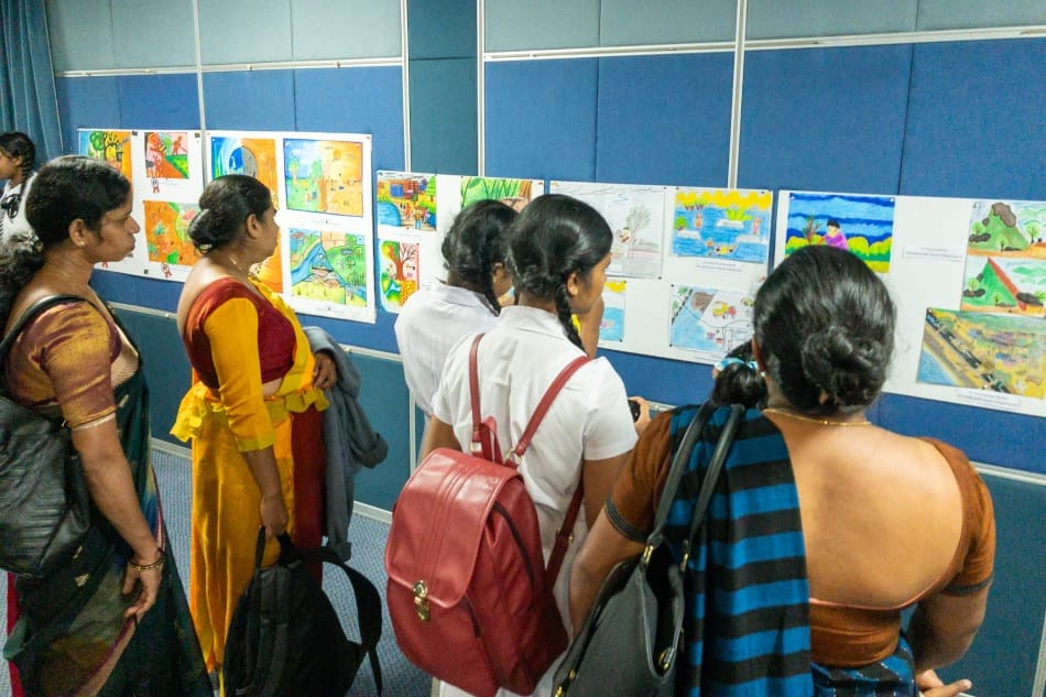 School children and teachers from the Nuwara Eliya district look at the art competition entries.